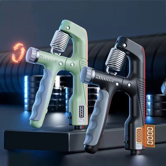 Two grip strength trainers, one green and one black, on a dark background with gym equipment.